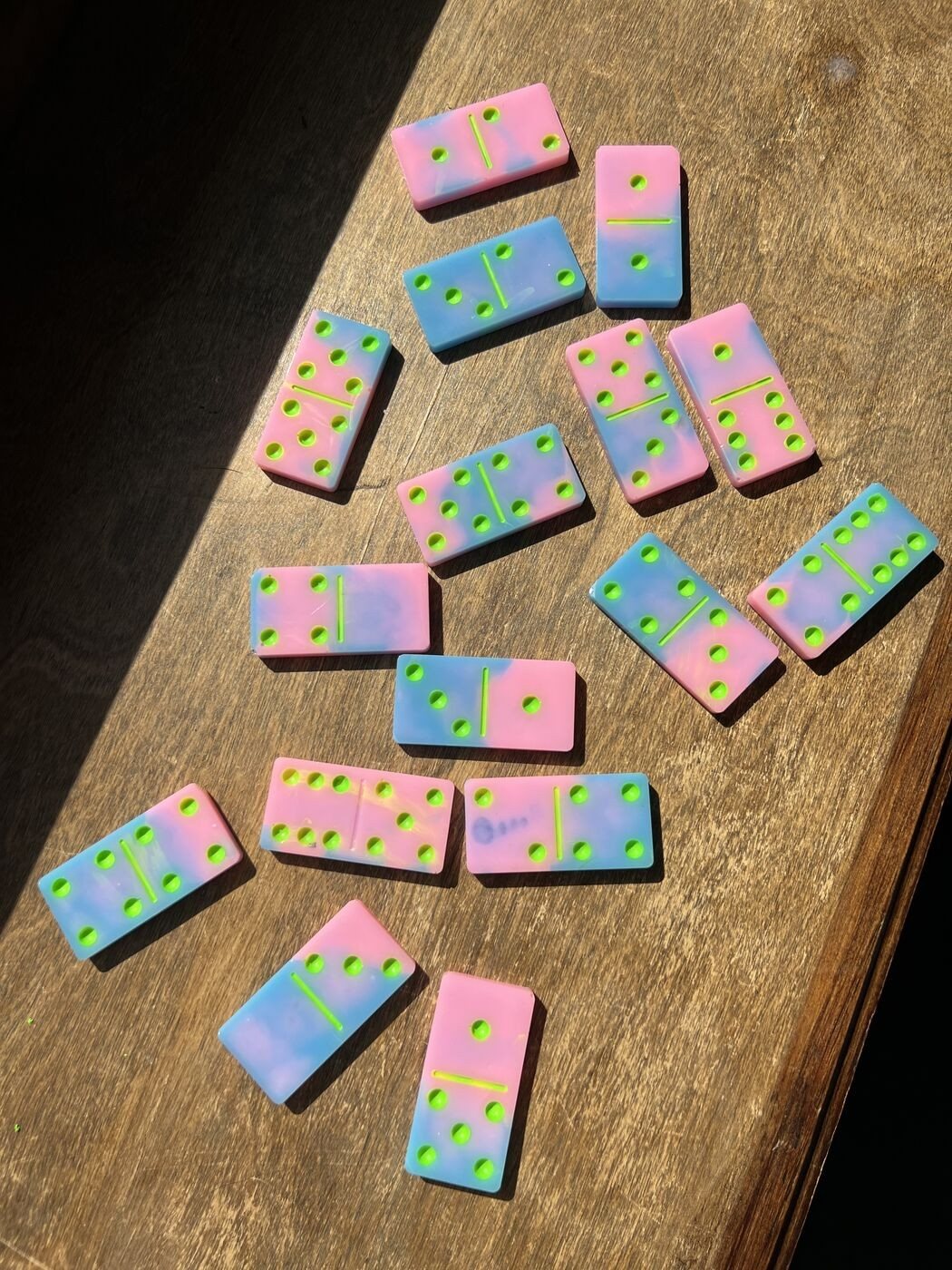 Pink and blue marbled resin dominoes with neon lime pips